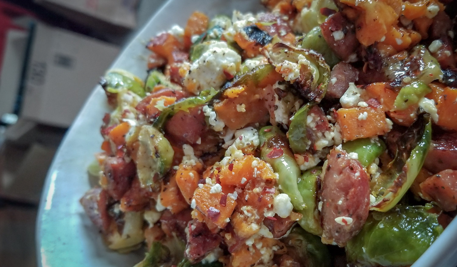 Roasted sweet potatoes, Brussels sprouts, and sausage with feta and honey mustard